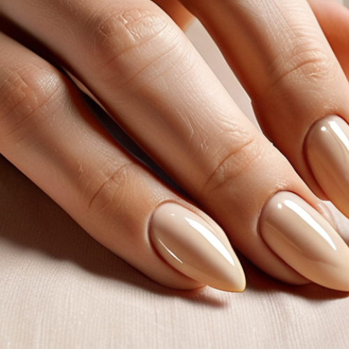 **Prompt:** Close-up of hands with almond-shaped nails painted in a creamy beige nude color. The nails feature delicate, thin gold line art. Soft, diffused natural light. Fall aesthetic.